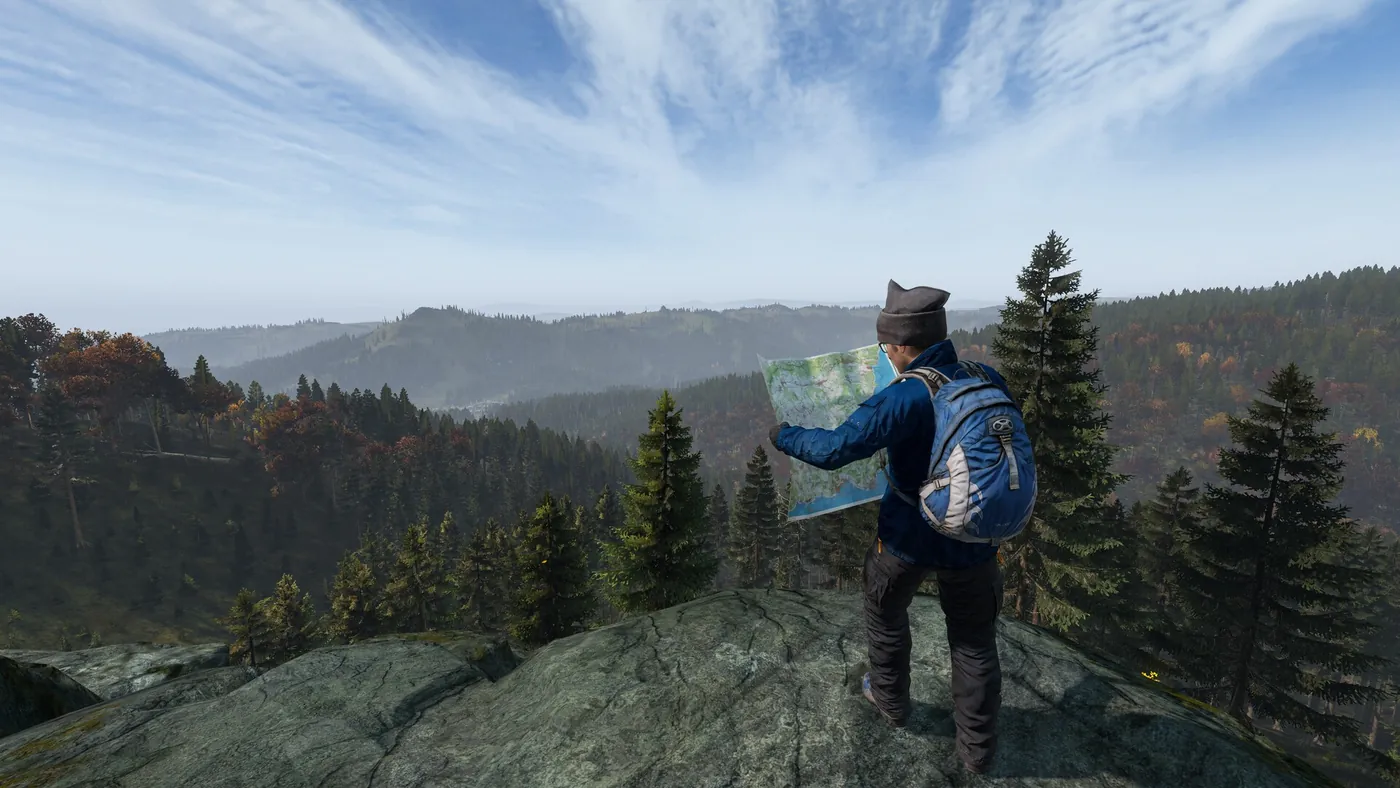 DayZ survivor reading a paper map on a rocky ridge above an autumn forest valley